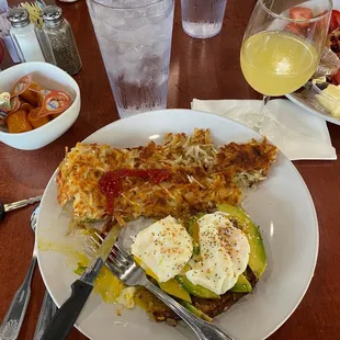 Avocado toast with hash browns &amp; mimosa. Also pictured: yummy waffle with fruit compote.