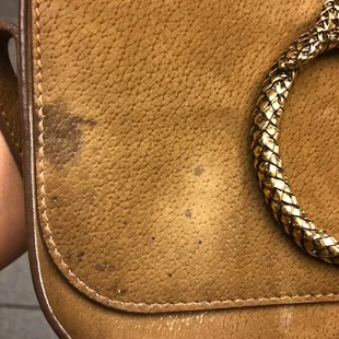 Before - a very stained purse + damage from an attempt to clean it.