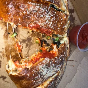 Small calzone with mushroom green peppers onions tomatoes and marinara