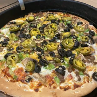 Ground beef black olives jalapeño mushrooms onion green pepper and a little cheddar on top