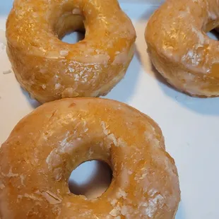 Glazed donuts from the night shift, still soft and fresh.