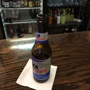 a bottle of beer on a napkin