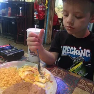 Happy little guy with his childrens cheese enchilada plate