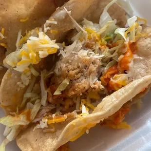 two tacos in a styrofoam container