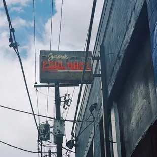 a neon sign on a pole