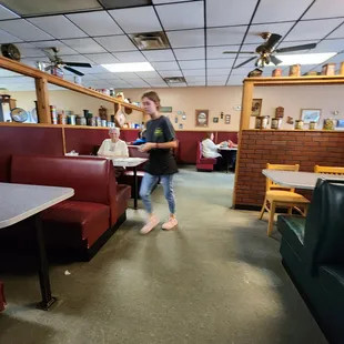 a young boy walking through the restaurant