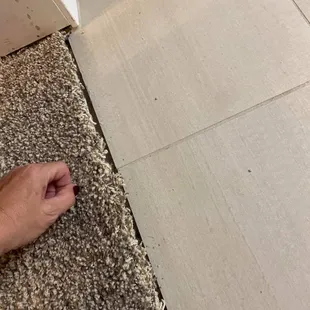 carpet was not tucked under and does not meet the tile
