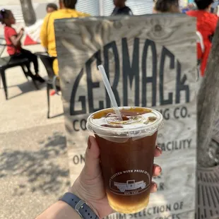 a hand holding a cup of coffee