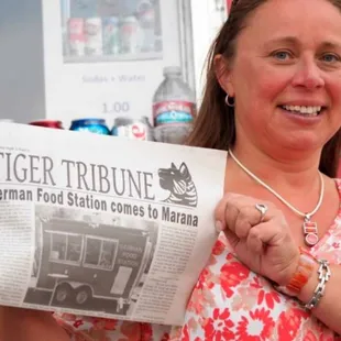 a woman holding a newspaper
