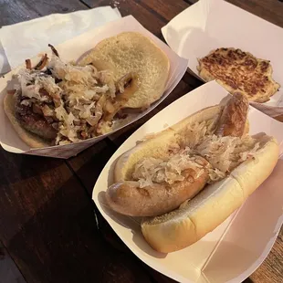 Potato pancake, bratwurst, and frikadellen with sauerkraut and cooked onions.