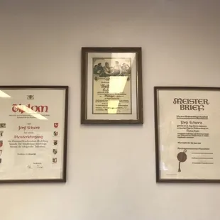 three framed plaques on a wall