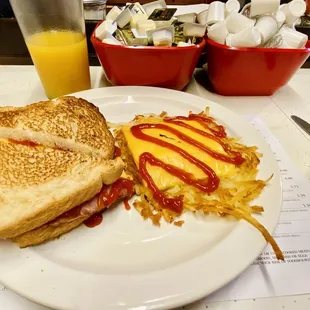Ham, egg and cheese sandwich with a side of hash browns.