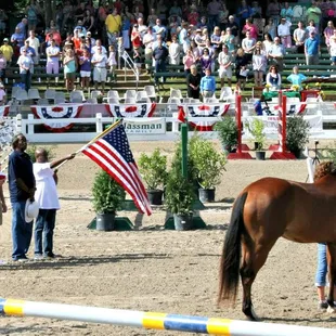 Clients of Alpha Omega Veterans Services leading horses at the Germantown Charity Horse Show with Southern Reins Center for Equine Therapy