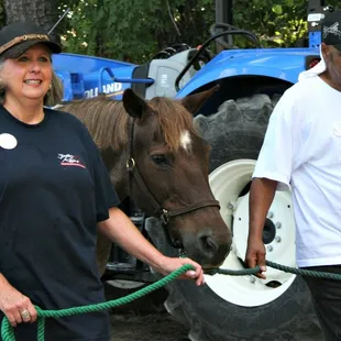 Clients of Alpha Omega Veterans Services leading horses at the Germantown Charity Horse Show with Southern Reins Center for Equine Therapy