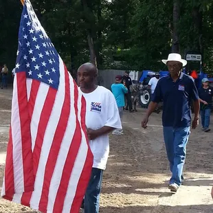 Clients of Alpha Omega Veterans Services leading horses at the Germantown Charity Horse Show with Southern Reins Center for Equine Therapy