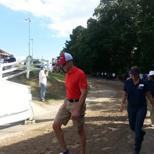 Clients of Alpha Omega Veterans Services leading horses at the Germantown Charity Horse Show with Southern Reins Center for Equine Therapy
