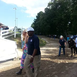 Clients of Alpha Omega Veterans Services leading horses at the Germantown Charity Horse Show with Southern Reins Center for Equine Therapy