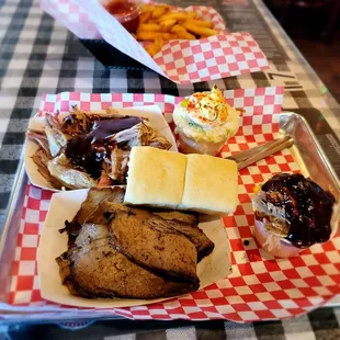 a plate of meat and sides