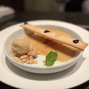 a plate of food with ice cream and a spoon