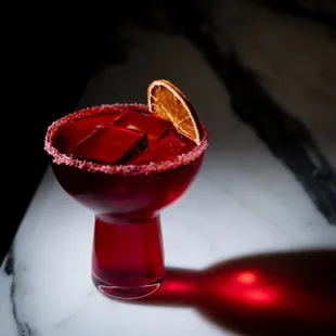 a margarita with a slice of orange