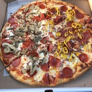 Build your own pizza! This is pepperoni bacon mushroom on half and banana peppers on half.
