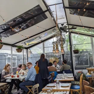 people sitting at tables in a restaurant