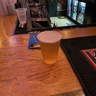 a pint of beer on a bar