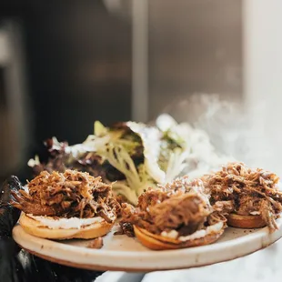 a plate of pulled pork sandwiches