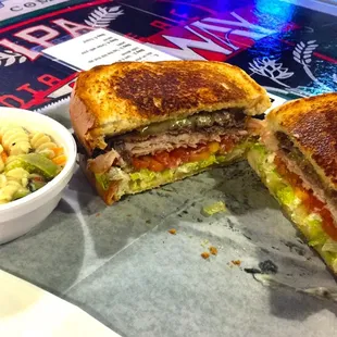Club sandwich with pasta salad. Thin cut bread Turkey roast beef and hamm