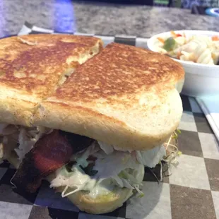 T.A.C. Added bacon. It has Turkey Avacado spread cream cheese and alfalfa sprouts. I add lettuce and tomato.