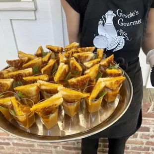 Tomato basil soup shot appetizer with grilled cheese.