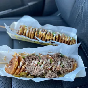 two pulled pork sandwiches in a car