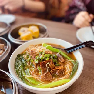 a bowl of soup with meat and vegetables