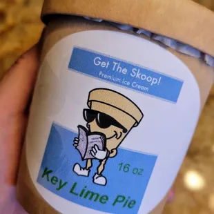 a hand holding a cup of ice cream