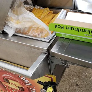 a fire extinguisher next to a box of hot tamales