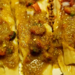 Three tamales with all the sauces used.