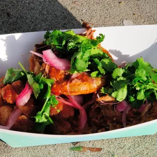 Three Yucatan Mini Tostadas $7.00. Beef, Carnitas, and Pork Belly. Served with Salsa, Cilantro, &amp; Pickled Onion.
