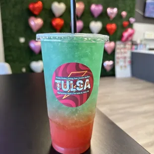 a colorful drink in a plastic cup