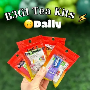 a person holding a bag of tea kits