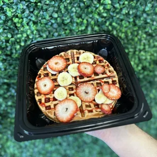 a waffle with strawberries and bananas