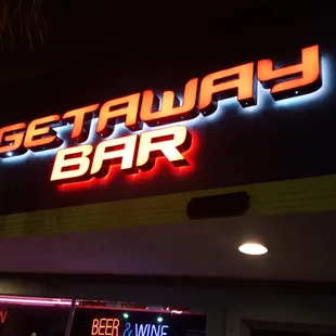 a neon sign on the side of a building
