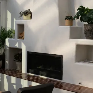 a patio with a fireplace and a table