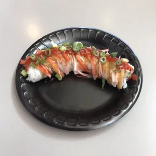 Angel Hair Roll.  Tuna, cream cheese and avocado, wrapped in seaweed, sushi rice, kanikama with a teriyaki glaze, topped with green onions.