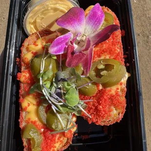 Mac and Cheese stuffed egg roll, dusted in flaming hot Cheetos. Topped with jalapeños. Sooooo goooooodddd.