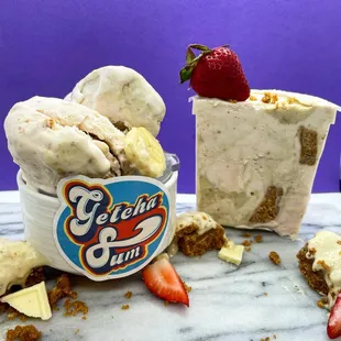 a bowl of ice cream and a cup of strawberries