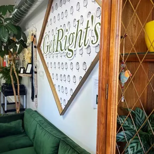 a green couch in front of a sign that says getrights