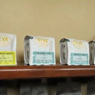 five bags of coffee on a shelf