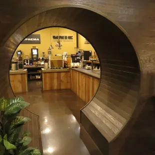 a view of a coffee shop through a circular window