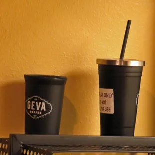 two cups of coffee on a shelf