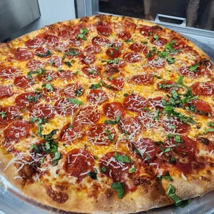 a pepperoni and basil pizza